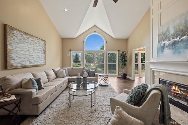 1257 Lake Shore Blvd, Lake Orion, MI 48362 - living room with a fireplace, high vaulted ceiling, ceiling fan, and wood finished floors