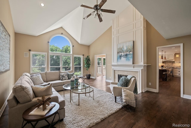 1257 Lake Shore Blvd, Lake Orion, MI 48362 - living room with dark wood-style floors, high vaulted ceiling, ceiling fan, and a tile fireplace
