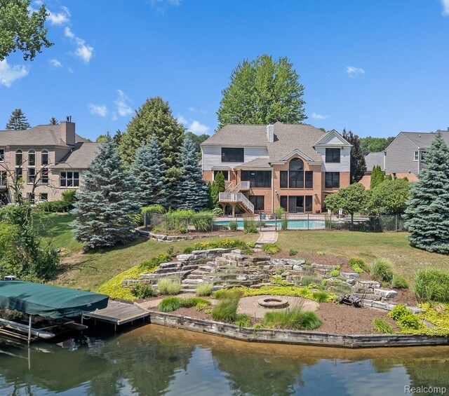 1257 Lake Shore Blvd, Lake Orion, MI 48362 - rear view of house featuring an outdoor fire pit, a water view, stairway, and brick siding