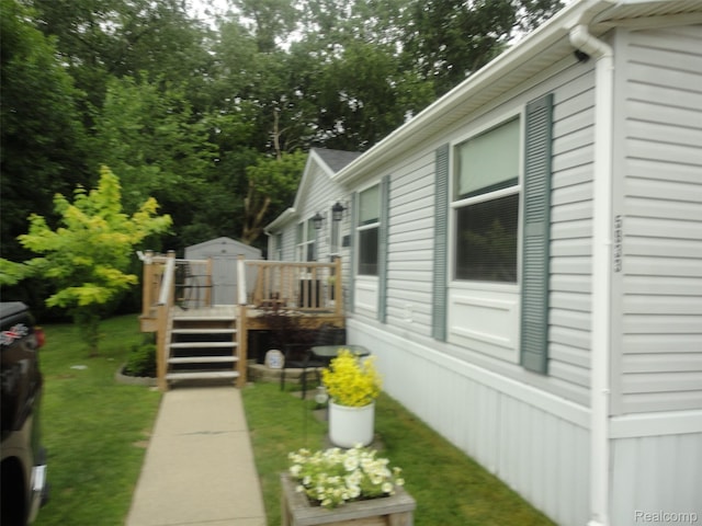 5933 Vernon, Belleville, MI 48111 - view of home's exterior with a wooden deck and a lawn