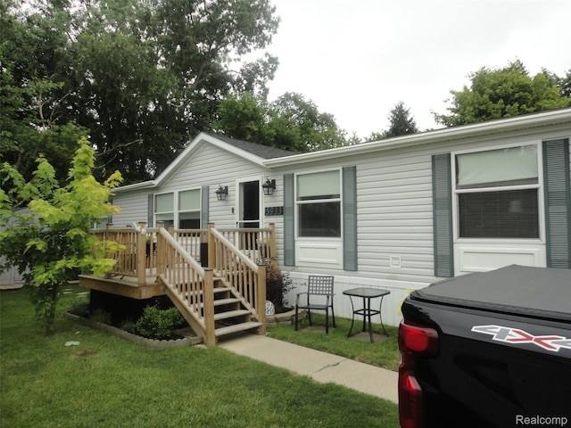 5933 Vernon, Belleville, MI 48111 - view of front of home with a front yard and a wooden deck