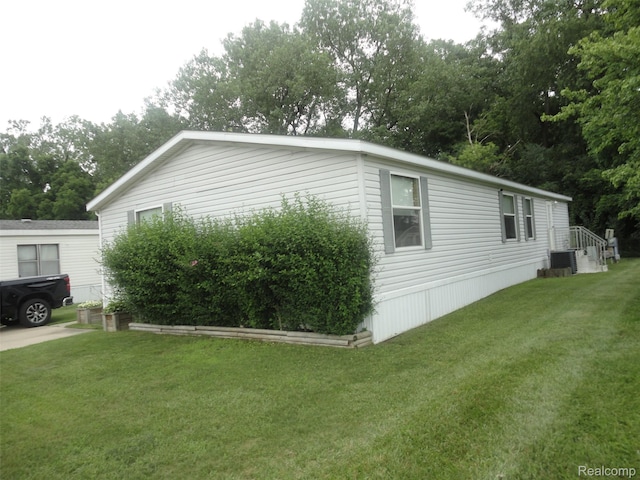 5933 Vernon, Belleville, MI 48111 - view of property exterior with a yard and view of scattered trees