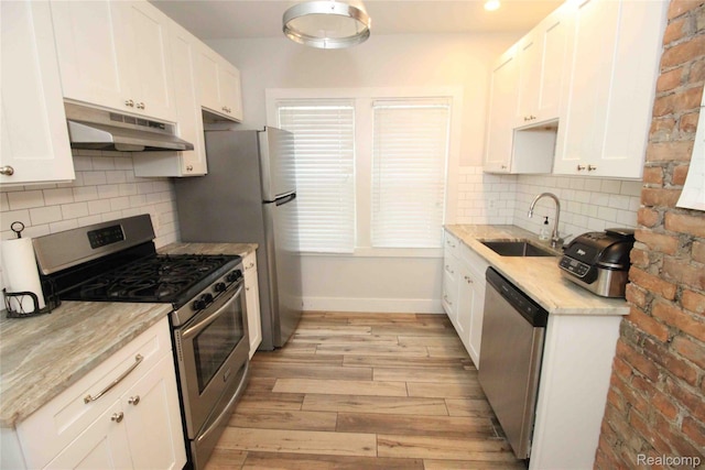 1324-1322 Wayburn St, Grosse Pointe, MI 48230 - kitchen with stainless steel appliances, under cabinet range hood, light wood finished floors, and white cabinetry
