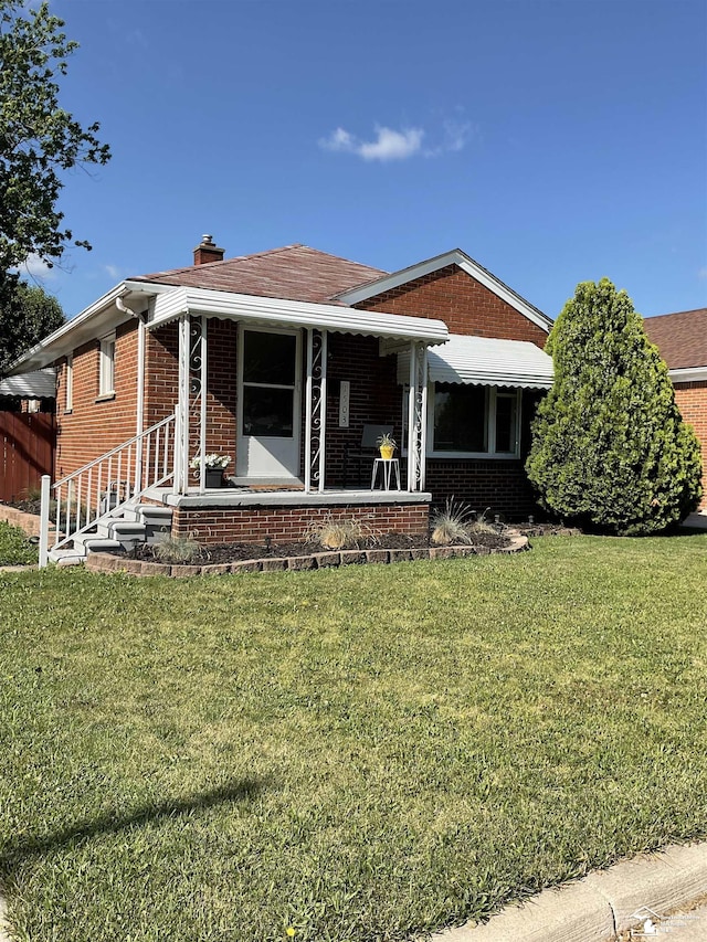 1503 Philomene Blvd, Lincoln Park, MI 48146 - rear view of property featuring brick siding, a lawn, and a chimney