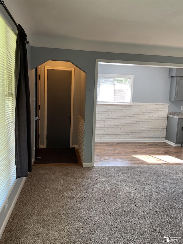 1503 Philomene Blvd, Lincoln Park, MI 48146 - carpeted empty room featuring arched walkways and brick wall