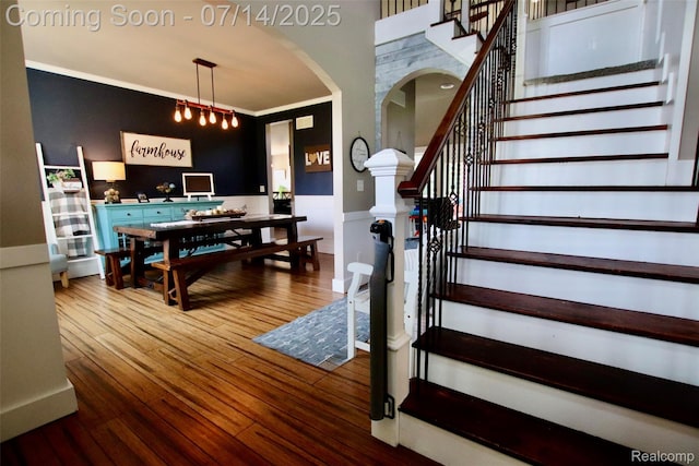 4385 Nelson Scott Dr, Holly, MI 48442 - staircase featuring arched walkways, wood-type flooring, and ornamental molding