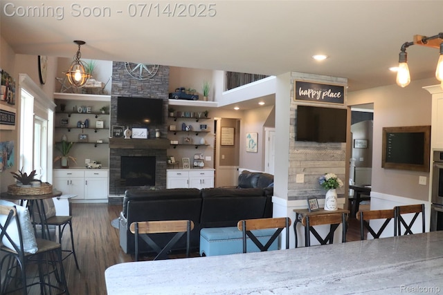 4385 Nelson Scott Dr, Holly, MI 48442 - living room with a fireplace and dark wood-style floors