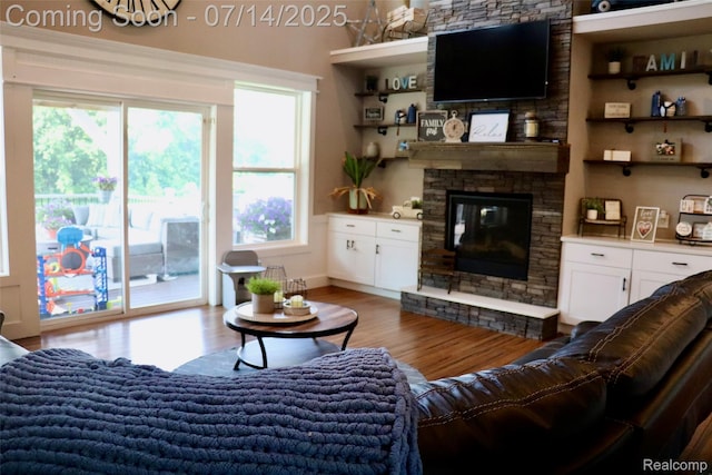 4385 Nelson Scott Dr, Holly, MI 48442 - living area featuring a stone fireplace and wood finished floors