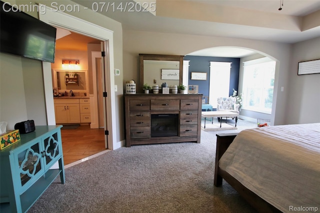4385 Nelson Scott Dr, Holly, MI 48442 - carpeted bedroom featuring arched walkways and connected bathroom