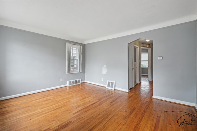 19007 Kentfield St, Detroit, MI 48219 - empty room with arched walkways and hardwood / wood-style floors