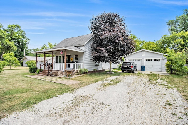 515 Locust St, Howard City, MI 49329 - view of front of property with covered porch, a garage, an outdoor structure, a front yard, and driveway