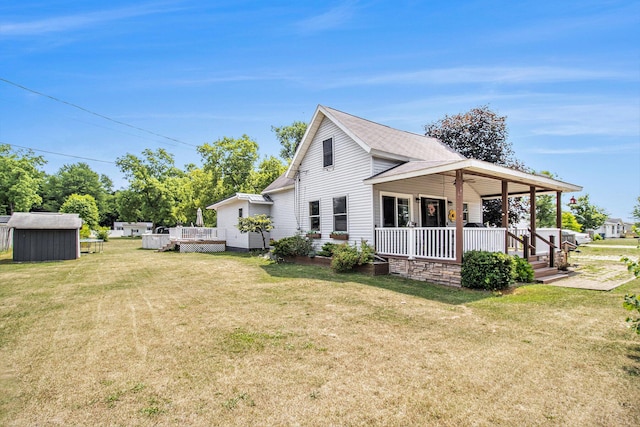 515 Locust St, Howard City, MI 49329 - view of side of property with covered porch, a storage unit, a yard, and a shingled roof
