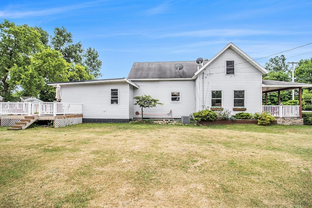 515 Locust St, Howard City, MI 49329 - back of house with a lawn, a shingled roof, and a deck