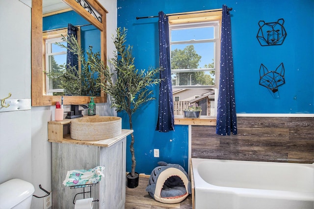 515 Locust St, Howard City, MI 49329 - full bathroom featuring a tub to relax in and wood finished floors
