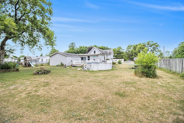 515 Locust St, Howard City, MI 49329 - view of yard featuring a playground and a wooden deck