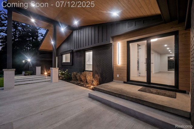 3539 Walbri Dr, Bloomfield Hills, MI 48304 - doorway to property featuring brick siding, board and batten siding, and french doors
