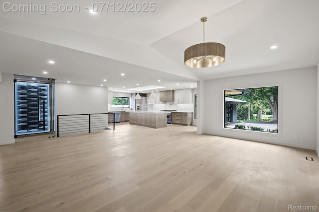 3539 Walbri Dr, Bloomfield Hills, MI 48304 - unfurnished living room featuring healthy amount of natural light, light wood-style floors, recessed lighting, and lofted ceiling