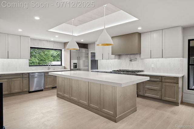 3539 Walbri Dr, Bloomfield Hills, MI 48304 - kitchen featuring appliances with stainless steel finishes, backsplash, light countertops, a center island, and wall chimney range hood