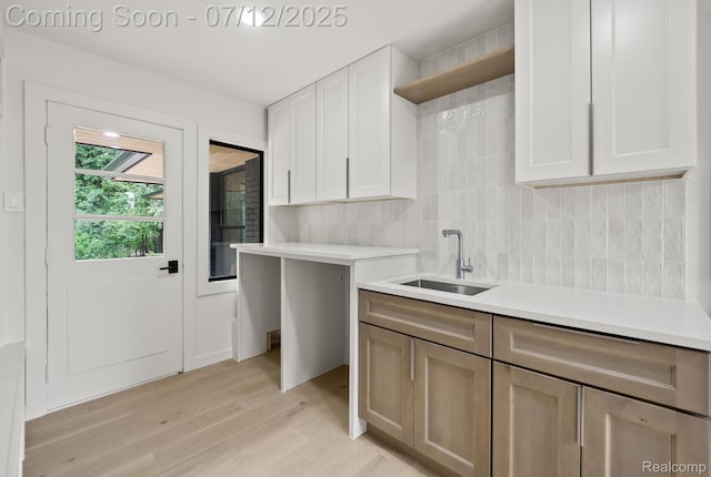 3539 Walbri Dr, Bloomfield Hills, MI 48304 - kitchen with light countertops, tasteful backsplash, light wood finished floors, and white cabinetry