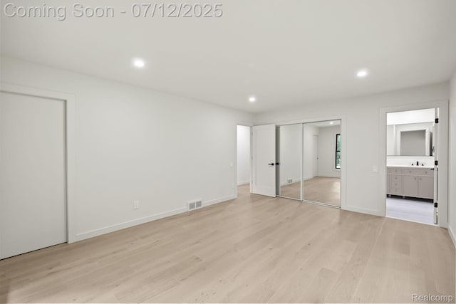 3539 Walbri Dr, Bloomfield Hills, MI 48304 - unfurnished bedroom with light wood-style flooring, recessed lighting, ensuite bathroom, and multiple closets