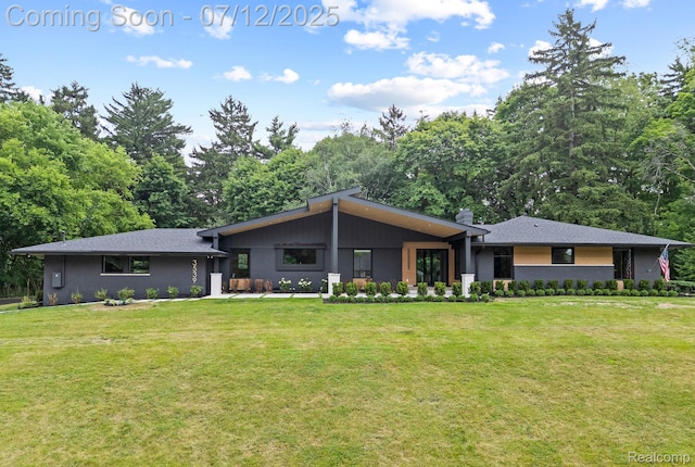 3539 Walbri Dr, Bloomfield Hills, MI 48304 - view of front of house with a front yard, brick siding, and view of wooded area
