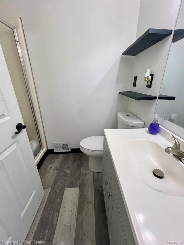 7270 Elizabeth Lake Rd, Waterford, MI 48327 - full bathroom with a shower stall, vanity, and wood finished floors