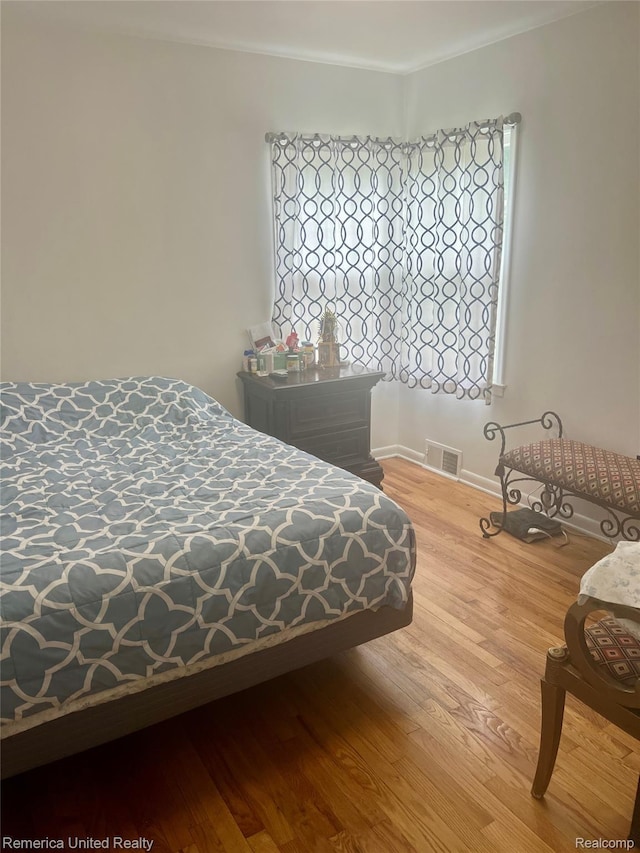 7270 Elizabeth Lake Rd, Waterford, MI 48327 - bedroom featuring wood finished floors and crown molding
