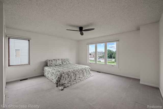 3410 Adams Shore Dr, Waterford, MI 48329 - bedroom featuring multiple windows, carpet flooring, a textured ceiling, and ceiling fan