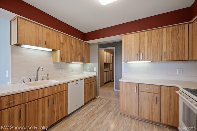 3410 Adams Shore Dr, Waterford, MI 48329 - kitchen featuring white appliances, light countertops, light wood-style floors, backsplash, and brown cabinetry