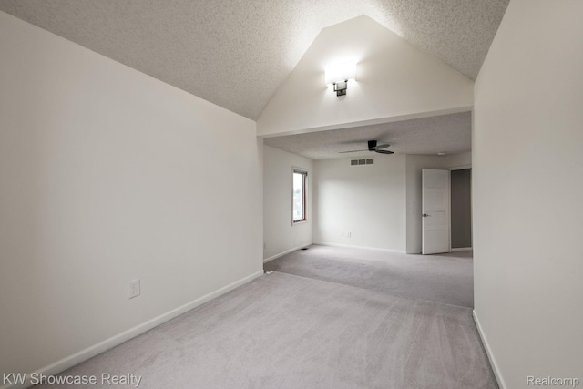 3410 Adams Shore Dr, Waterford, MI 48329 - carpeted empty room featuring a textured ceiling, ceiling fan, and vaulted ceiling