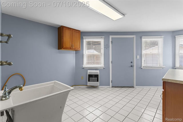 1868 Treadwell St, Westland, MI 48186 - kitchen featuring heating unit, brown cabinets, light tile patterned floors, and light countertops