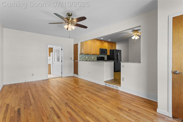 1868 Treadwell St, Westland, MI 48186 - kitchen featuring ceiling fan, black appliances, light wood-type flooring, and backsplash