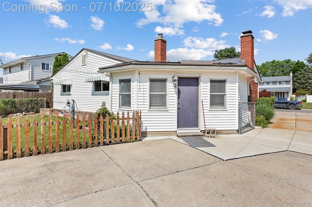 1868 Treadwell St, Westland, MI 48186 - view of front of house featuring a chimney, a patio, and entry steps