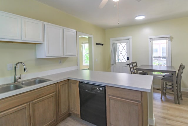 637 Prospect Ave NE, Grand Rapids, MI 49503 - kitchen featuring black dishwasher, a peninsula, light countertops, light wood finished floors, and a ceiling fan
