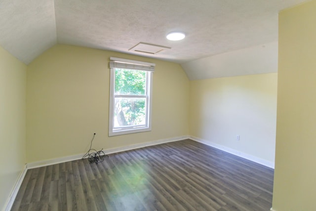637 Prospect Ave NE, Grand Rapids, MI 49503 - additional living space with dark wood finished floors, lofted ceiling, and a textured ceiling