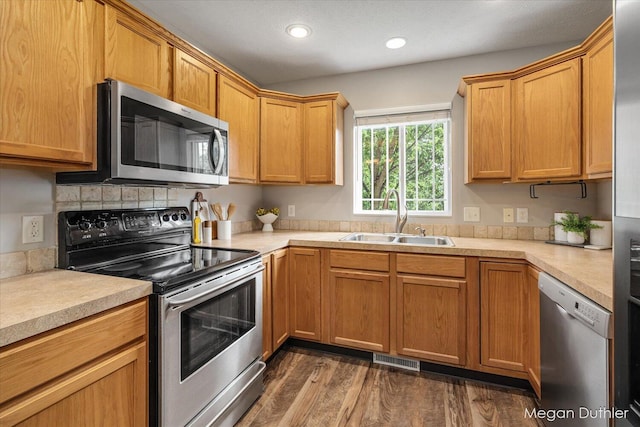 2948 Stoney Creek Ct, Hudsonville, MI 49426 - kitchen featuring stainless steel appliances, dark wood-style flooring, light countertops, and recessed lighting