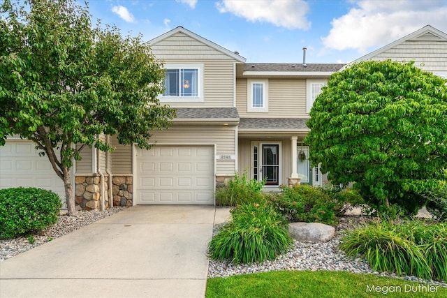 2948 Stoney Creek Ct, Hudsonville, MI 49426 - view of front facade with an attached garage, driveway, roof with shingles, and stone siding