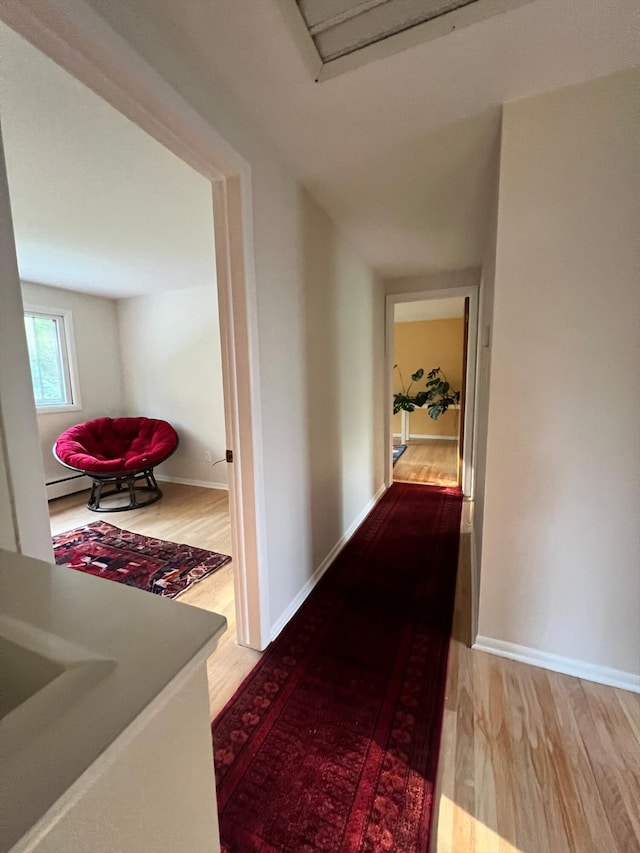 2422 Essex, Ann Arbor, MI 48104 - hall with wood finished floors and a baseboard radiator