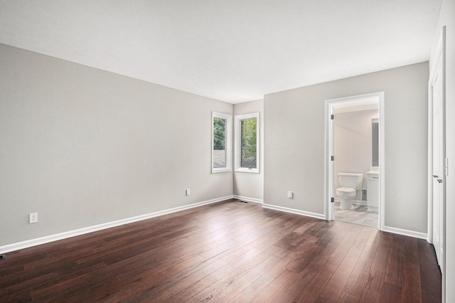 1721 Fountainview Ct SE, Caledonia, MI 49316 - unfurnished bedroom featuring dark wood-style floors and connected bathroom