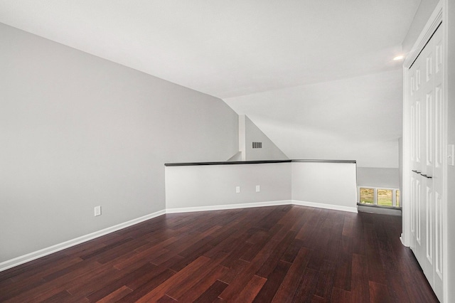 1721 Fountainview Ct SE, Caledonia, MI 49316 - additional living space featuring dark wood-type flooring and vaulted ceiling