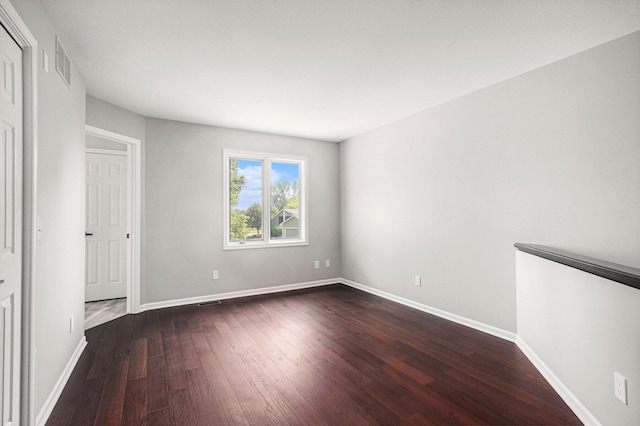 1721 Fountainview Ct SE, Caledonia, MI 49316 - unfurnished bedroom featuring dark wood-style flooring and baseboards