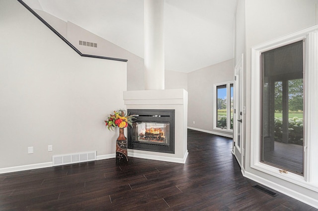 1721 Fountainview Ct SE, Caledonia, MI 49316 - unfurnished living room with high vaulted ceiling, wood finished floors, and a multi sided fireplace