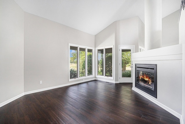 1721 Fountainview Ct SE, Caledonia, MI 49316 - unfurnished living room featuring high vaulted ceiling, a glass covered fireplace, and dark wood-style floors