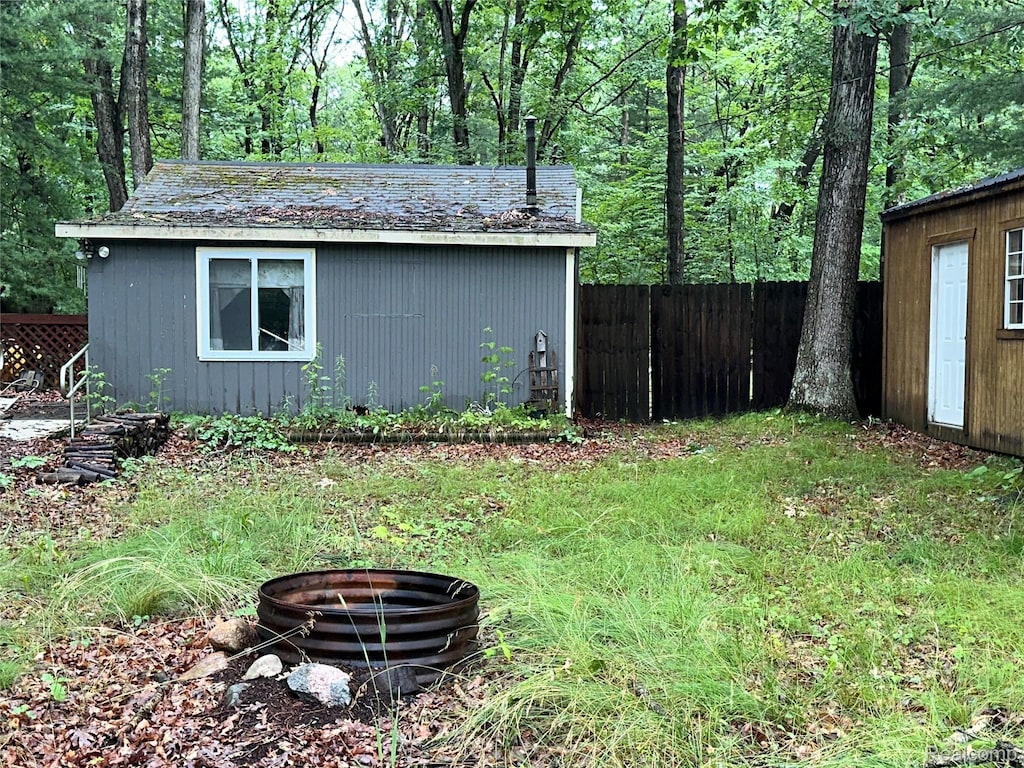2673 Ivan, Harrison, MI 48625 - view of outbuilding featuring a fire pit