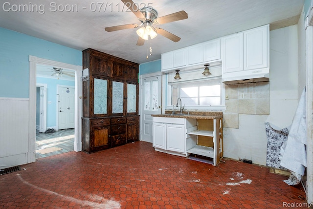 77 Hubbard St, Mount Clemens, MI 48043 - kitchen featuring ceiling fan, white cabinetry, a wainscoted wall, open shelves, and under cabinet range hood