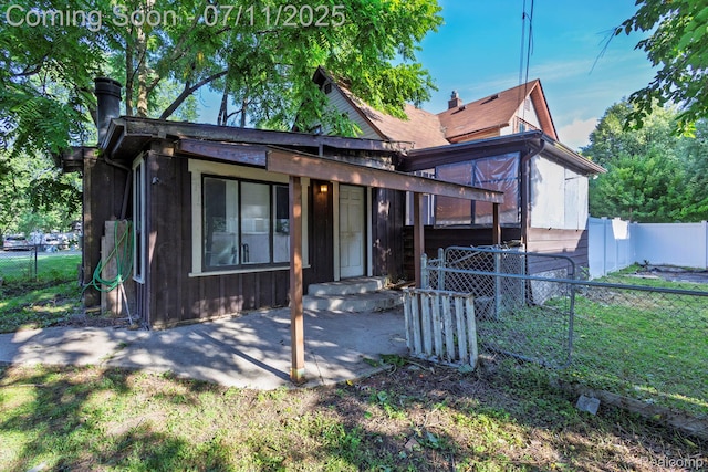 77 Hubbard St, Mount Clemens, MI 48043 - view of front of house featuring a fenced backyard and a chimney