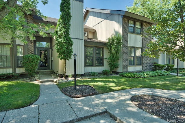 25279 Greenbrooke Dr, Southfield, MI 48033 - property entrance with a yard and brick siding