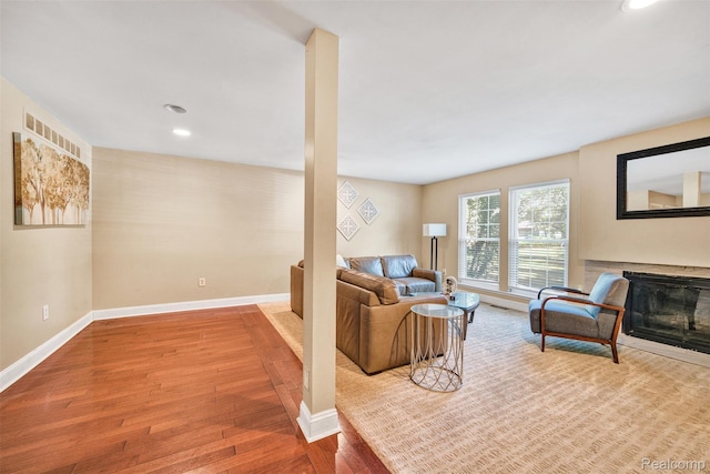 25279 Greenbrooke Dr, Southfield, MI 48033 - living room with a glass covered fireplace, wood finished floors, and recessed lighting