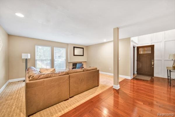 25279 Greenbrooke Dr, Southfield, MI 48033 - living room with wood finished floors, a fireplace, and recessed lighting