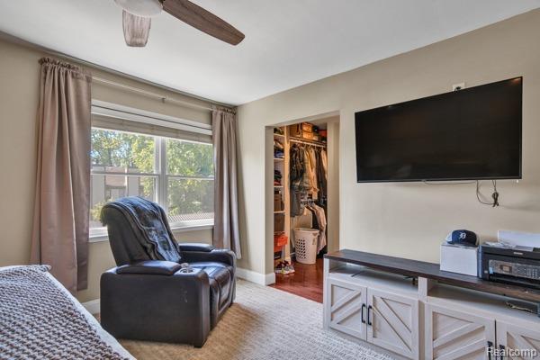 25279 Greenbrooke Dr, Southfield, MI 48033 - bedroom with a walk in closet, a closet, and a ceiling fan